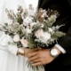 bridge and groom standing while holding flower bouquet
